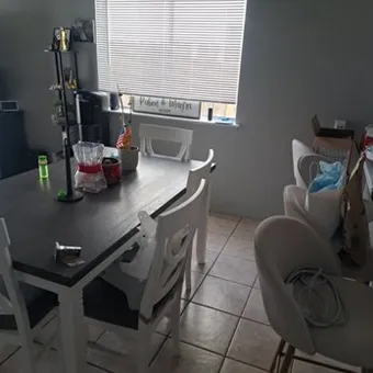 The same dining table and floor cleared and wiped down after cleaning