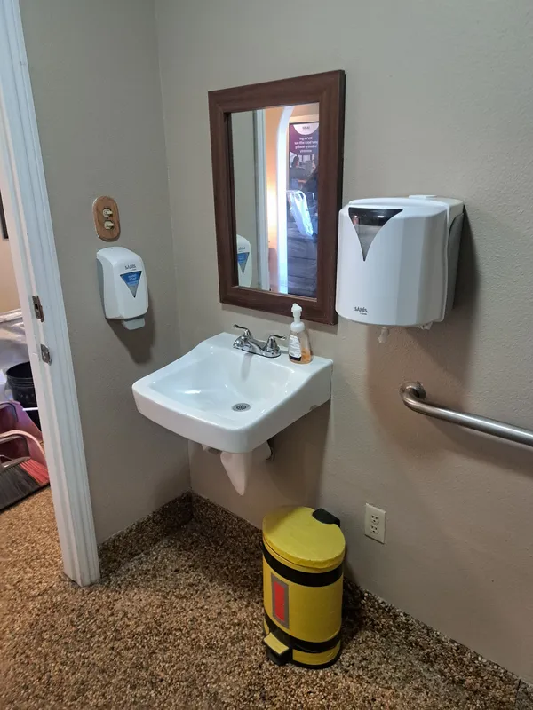 Commercial restroom with a wall sink and grab bar