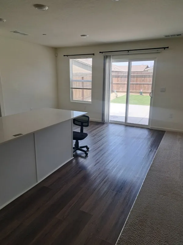 Empty room with a sliding glass door to the yard