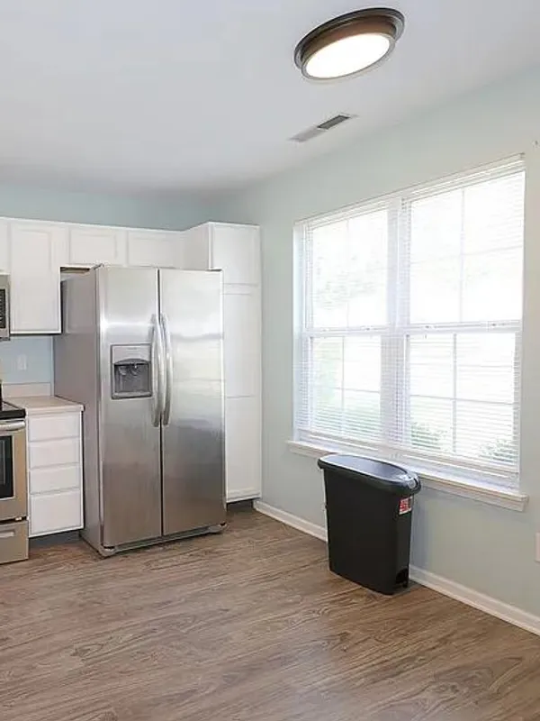 Empty white kitchen with stainless appliances