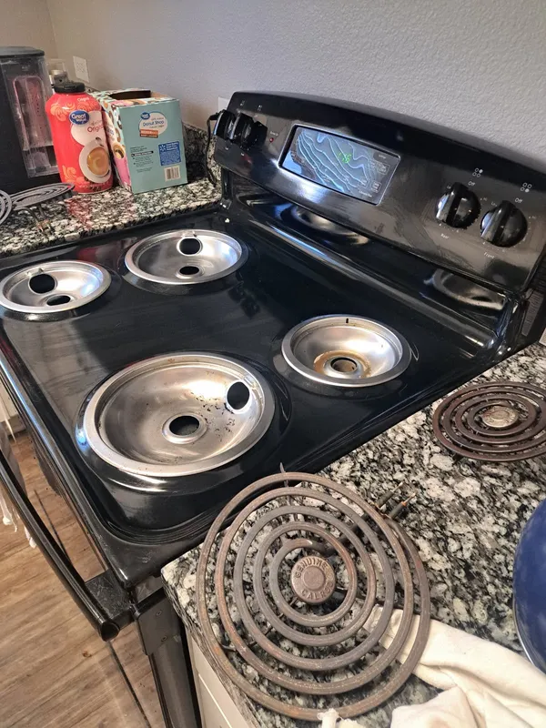Stovetop with the drip pans and burner coils lifted out