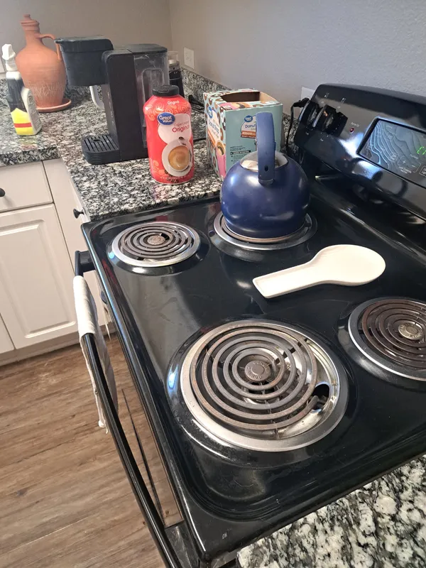 Electric stovetop with a blue kettle