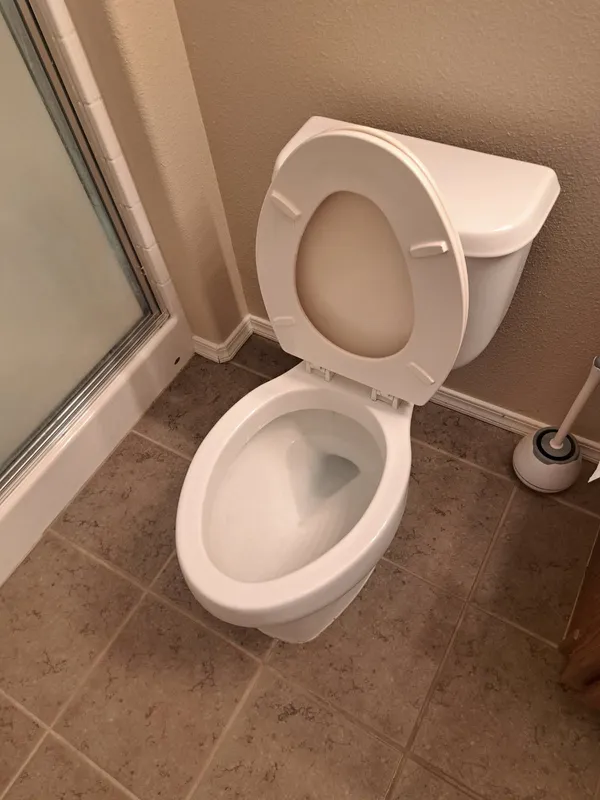 Clean white toilet in a tiled bathroom
