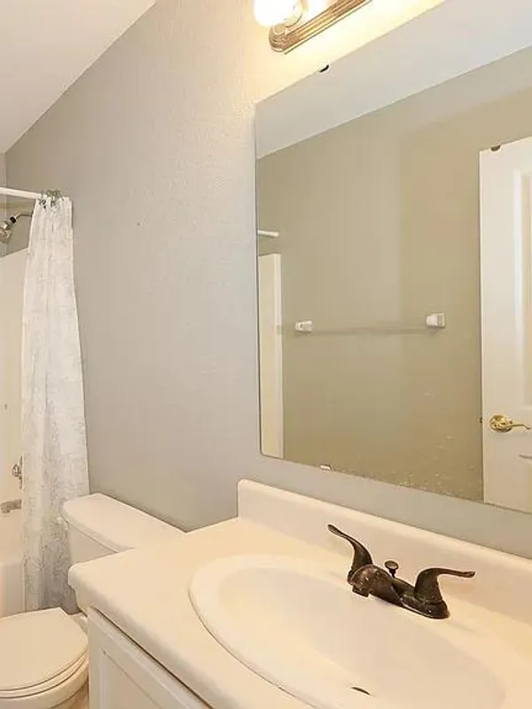 Bathroom with a tub and shower, toilet and sink